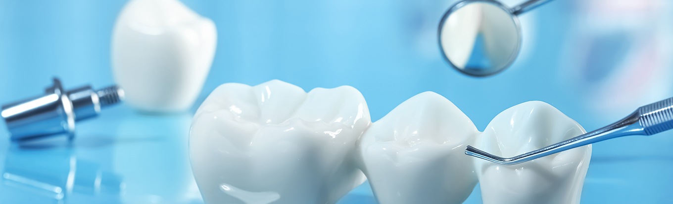 Dental bridge next to dental instruments