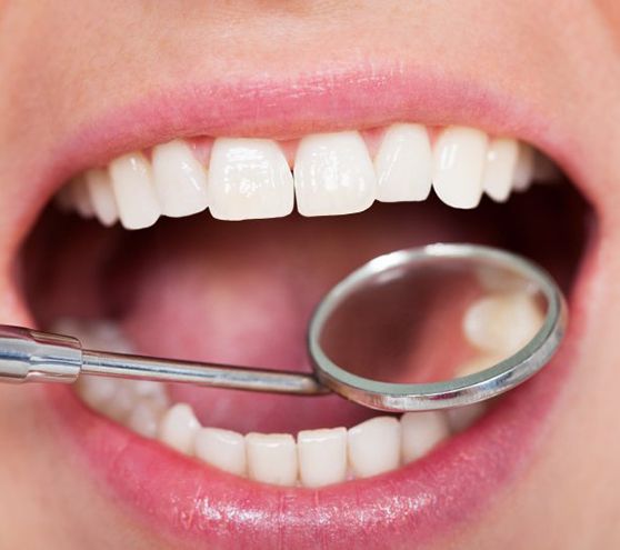 Teeth examined with dental mirror