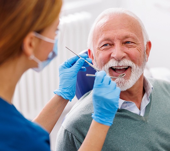 Man smiles at dental hygienist