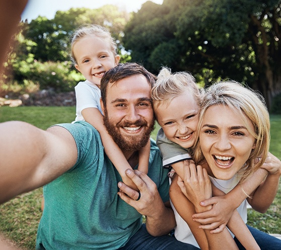 Happy family taking selfie outdoors