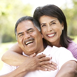 happy couple enjoying the day-to-day benefits of dental implants in Owings Mills