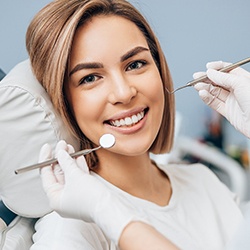 Woman smiling during a routine dental checkup