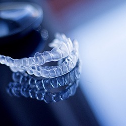 Two aligners for Invisalign in Owings Mills, MD on a clear table