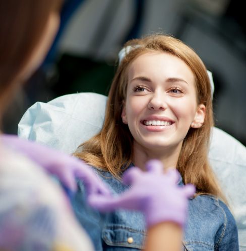 smiling woman talking to dentist
