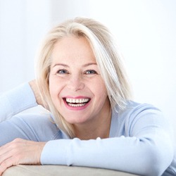 woman laughing and smiling in light blue shirt