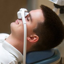 Male patient smiling while breathing in nitrous oxide