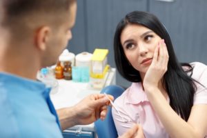 A woman listening to a dentist.