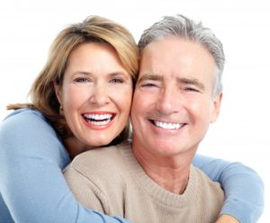 a man and woman smiling and hugging