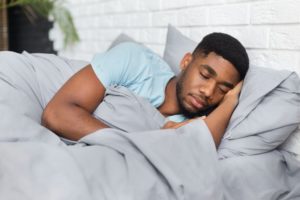 Man sleeping under a weighted blanket