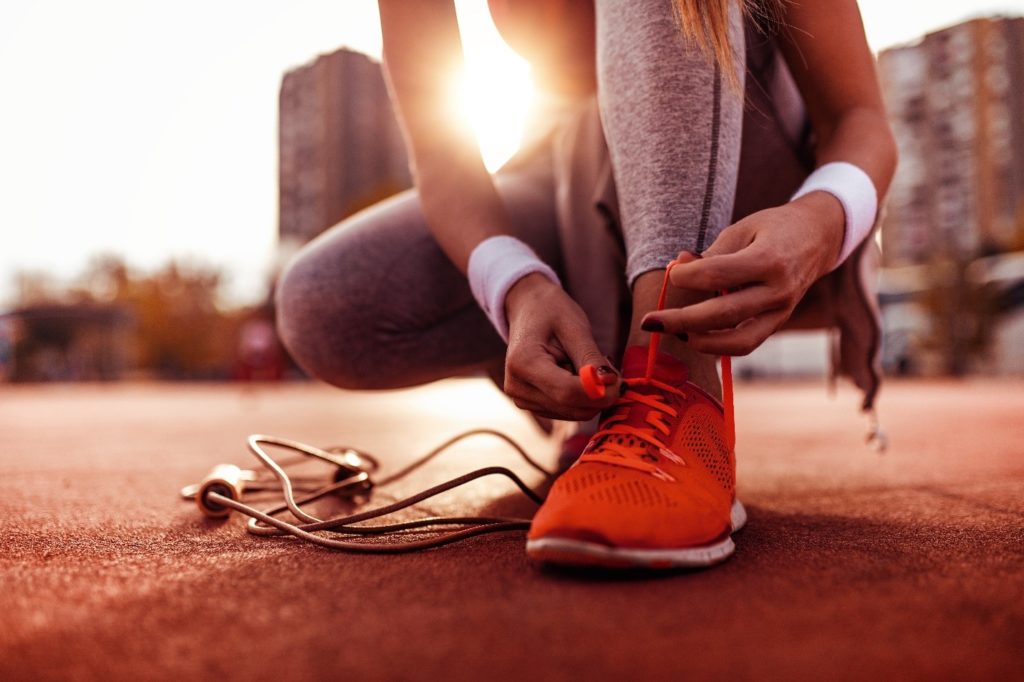 Closeup of woman tying her running shoes