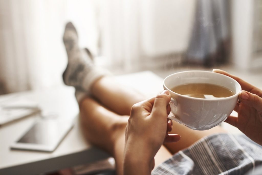 Person drinking coffee on peaceful morning