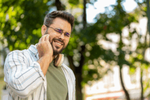 a young adult man dealing with TMJ pain